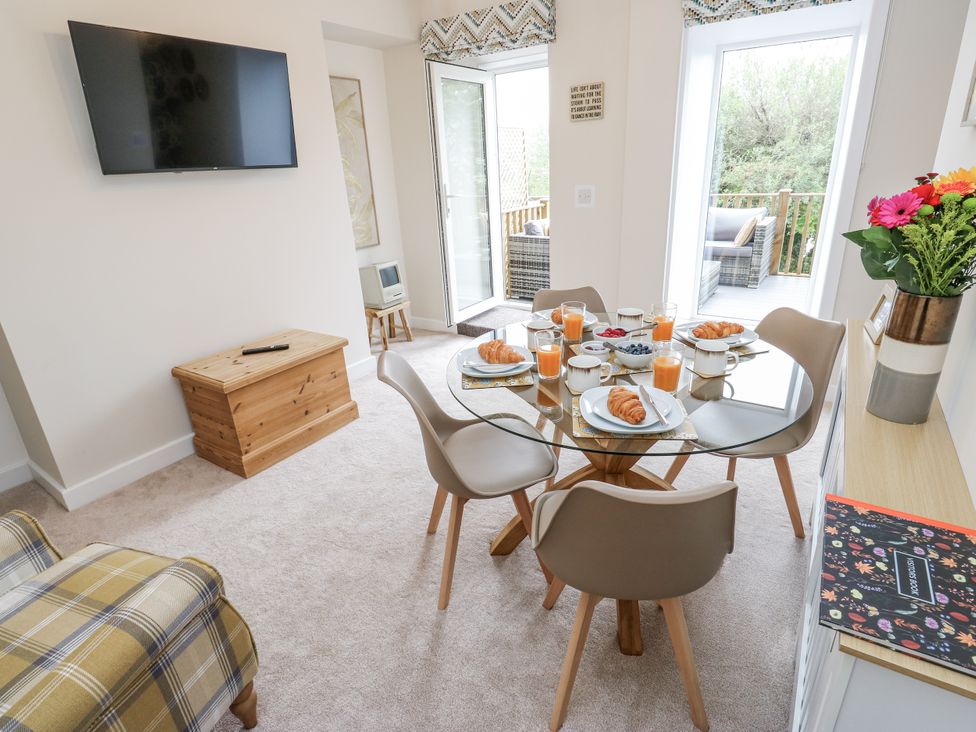 A dining area with a table and chairs at Millside View