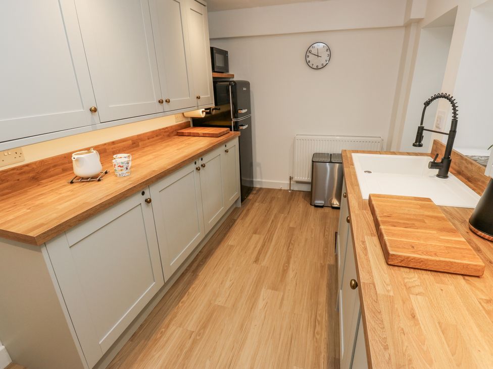 A kitchen with cabinets and a sink at Millside View located in 