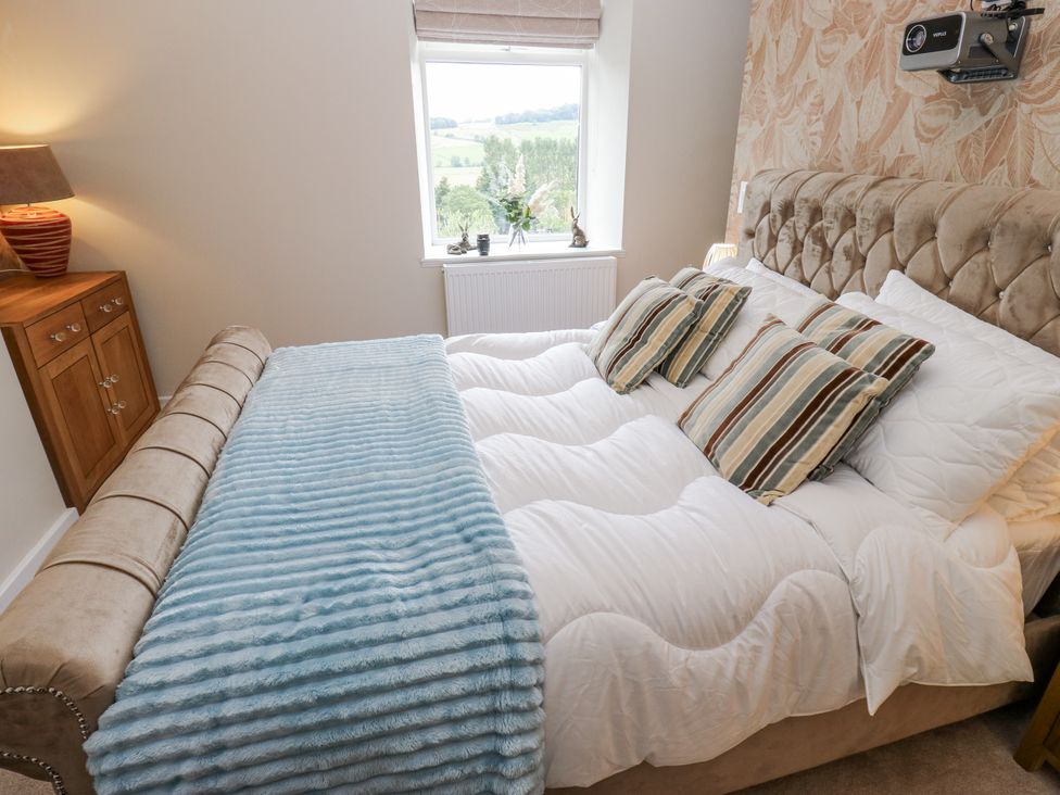 A bedroom with a bed and window at Millside View in 