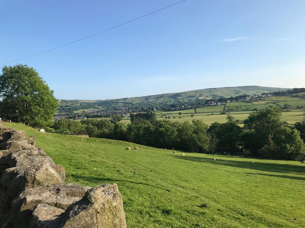 A view of hills and sheep in a field at Millside View in Kildwick