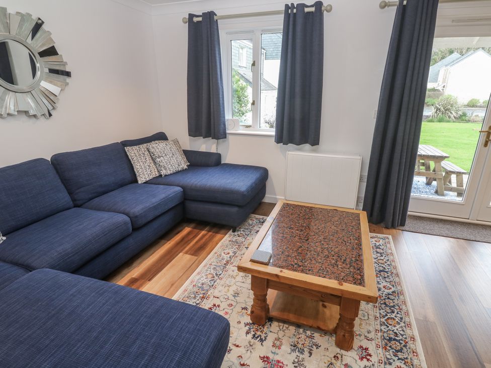A living room with a sofa and coffee table at Chellowdene Cottage in Falmouth