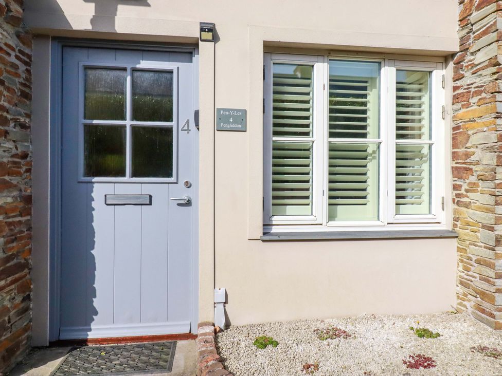 A door and window with a stone wall at Pen-Y-Les in Wadebridge