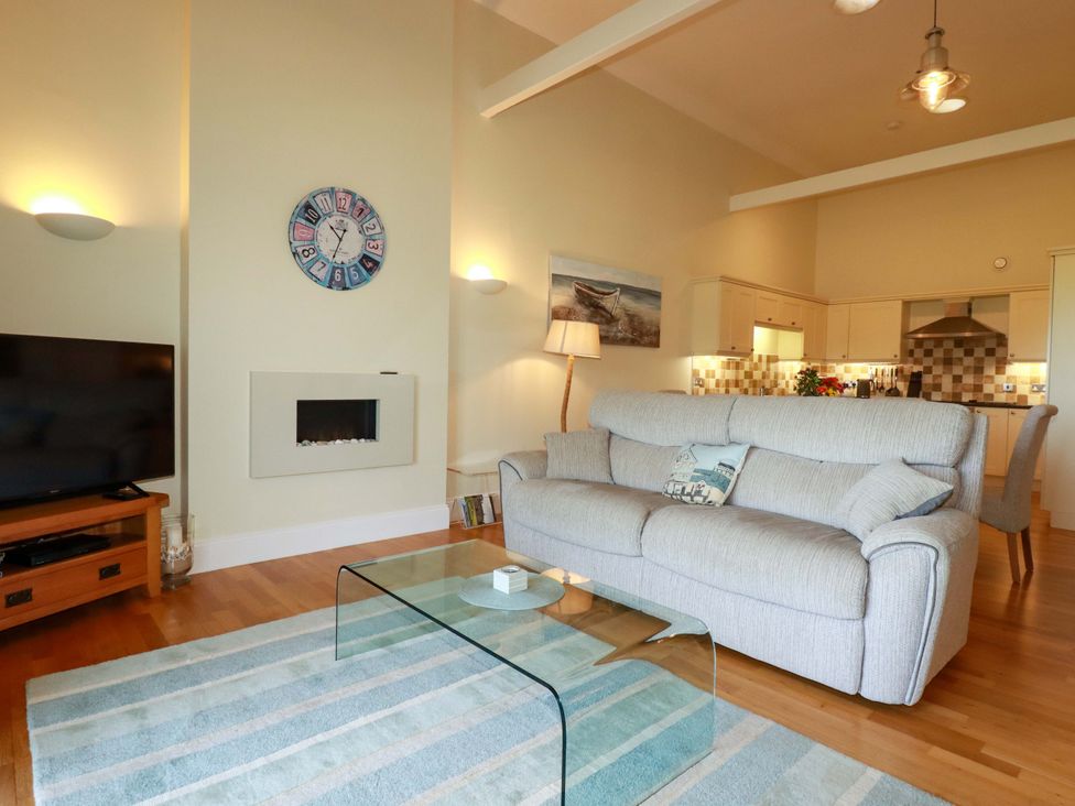 A living room with a sofa and television at Pen-Y-Les in Wadebridge