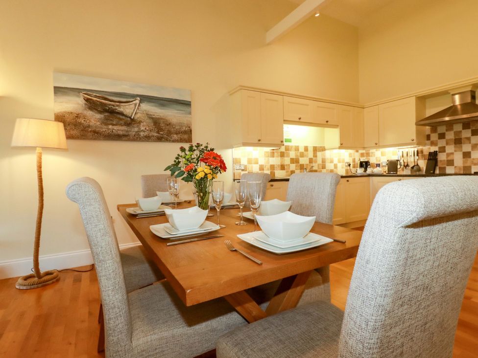 A dining room with a table set for dinner at Pen-Y-Les Wadebridge