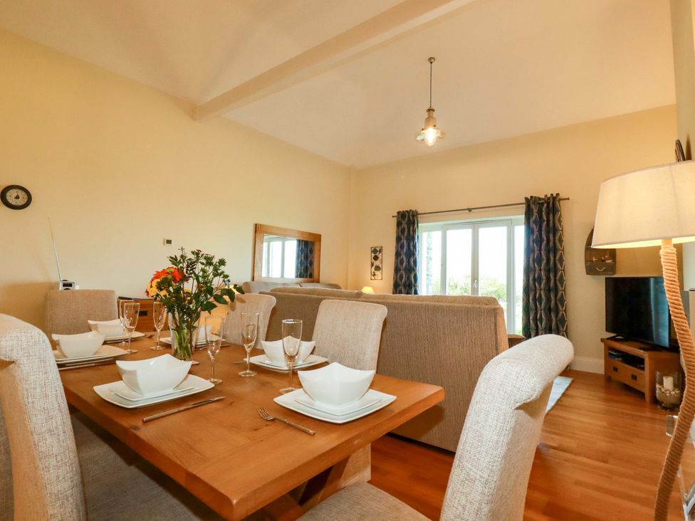 A dining room with a table set for dinner at Pen-Y-Les Wadebridge