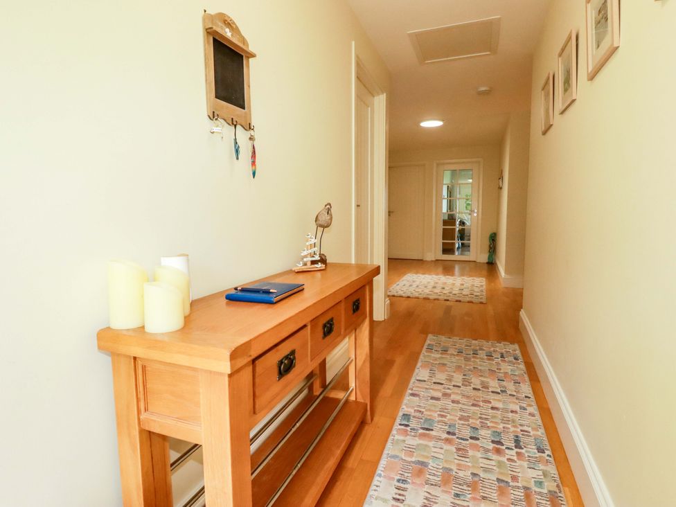 A hallway with a console table and decorative items at Pen-Y-Les in Wadebridge