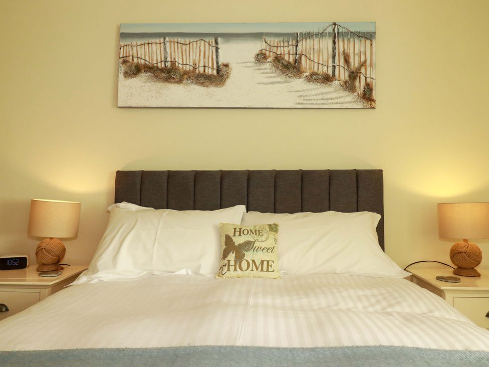 A bedroom with a bed and lamps at Pen-Y-Les in Wadebridge