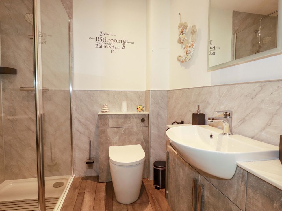 A bathroom with a shower, sink, and toilet at Pen-Y-Les Wadebridge