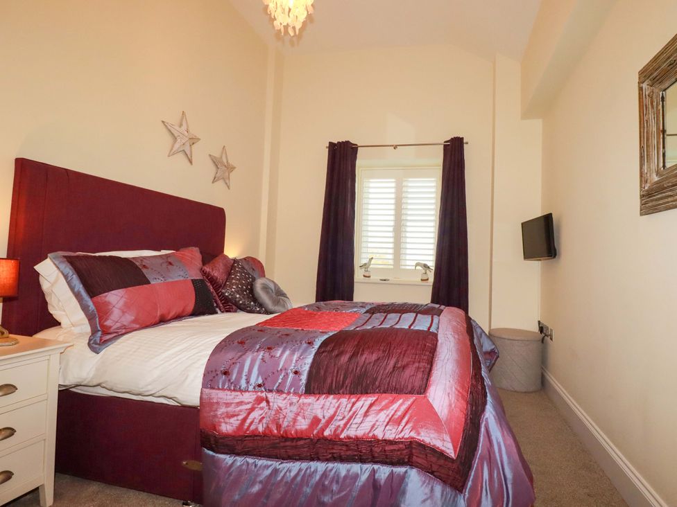 A bedroom with a bed and window at Pen-Y-Les in Wadebridge