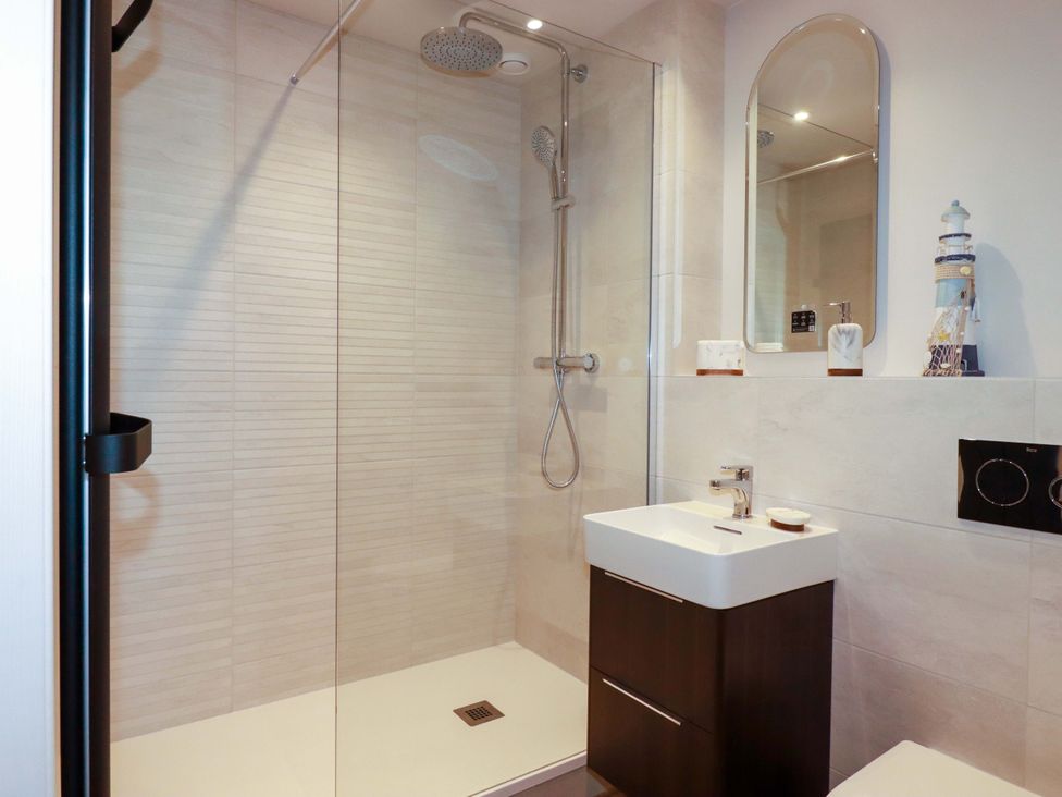 A bathroom with a shower and sink at Pen-Y-Les in Wadebridge