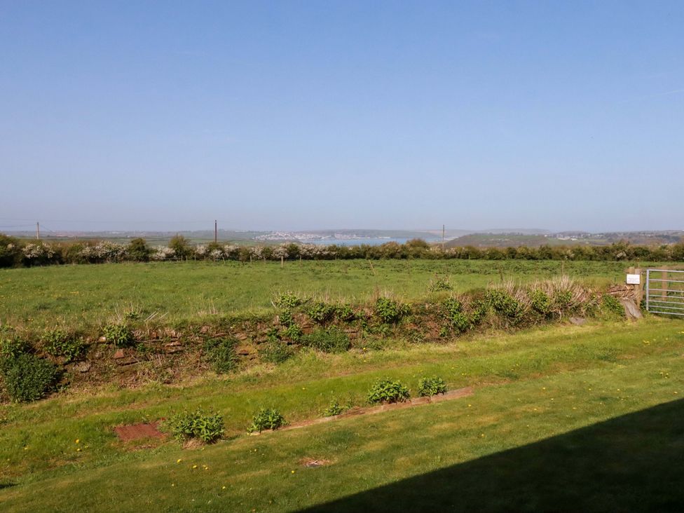 A view of grassland and distant water at Pen-Y-Les in Wadebridge