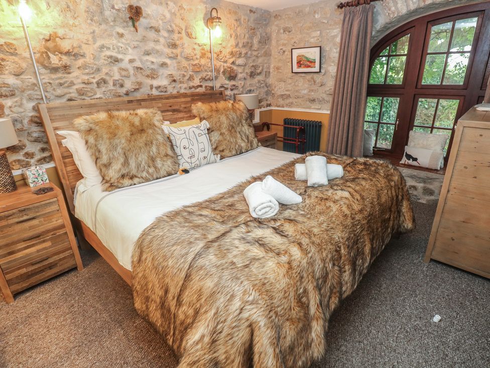 A bedroom with a double bed and bedside tables at Coach House Haverfordwest near Broad Haven