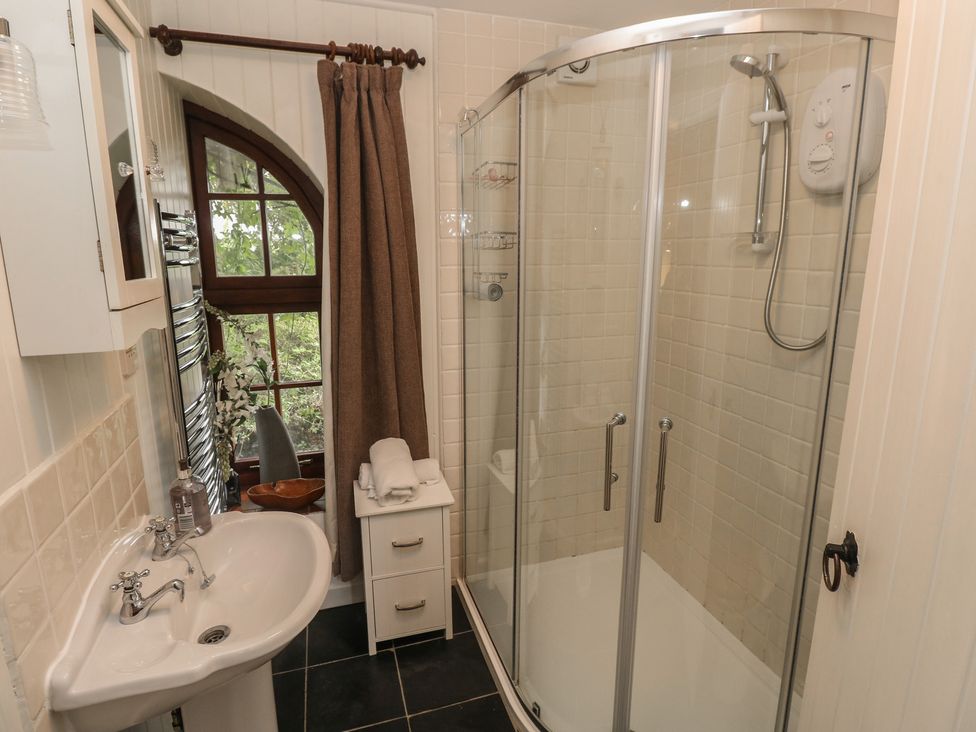 A bathroom with a shower and sink at Coach House Haverfordwest near Broad Haven