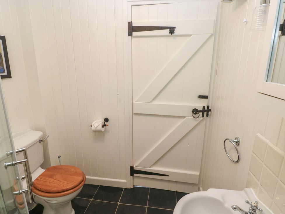 A bathroom with a toilet and washbasin at Coach House Haverfordwest near Broad Haven