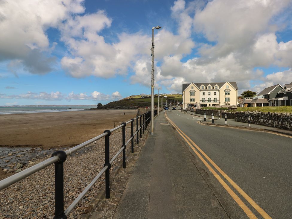 A beach view with a road and buildings at Coach House Haverfordwest near Broad Haven