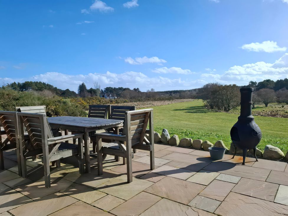 An outdoor seating area with a table and chairs at Red Squirrel in Dornoch