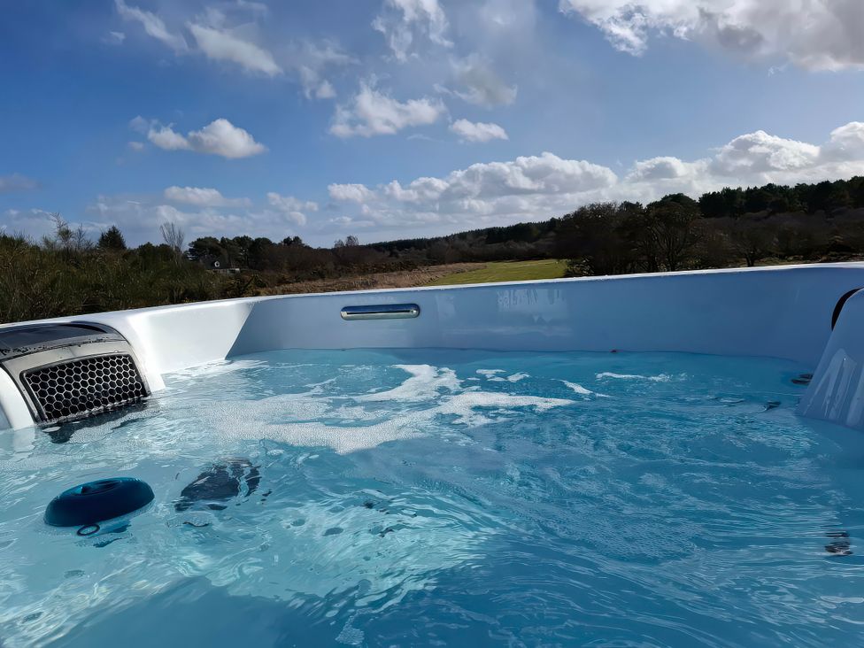 A hot tub with water and bubbles at Red Squirrel in Dornoch
