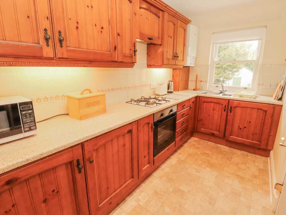 A kitchen with cabinets and appliances at Flat 17 in Keswick