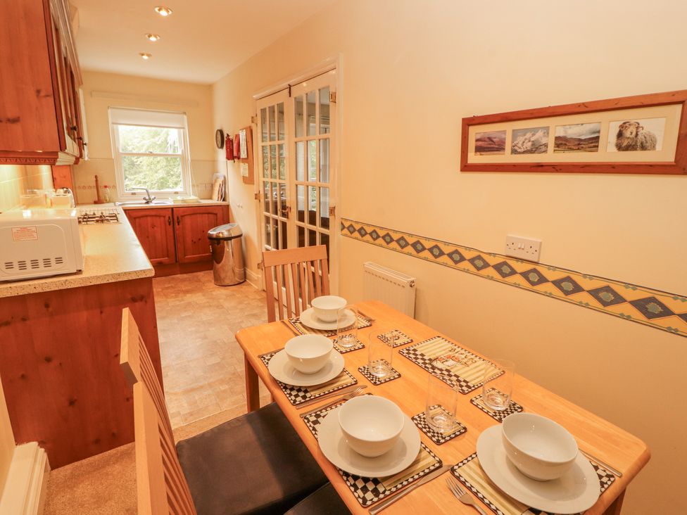 A dining room with a table set for meals at Flat 17 in Keswick
