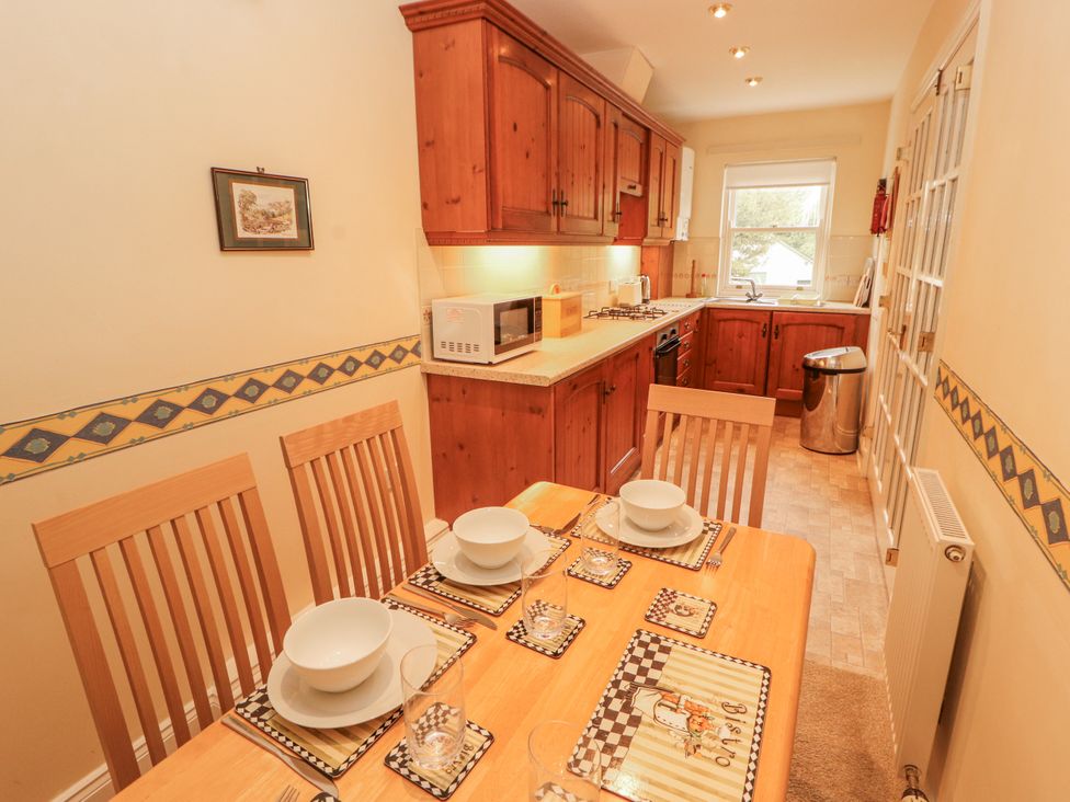A dining room with a table set for a meal at Flat 17 in Keswick