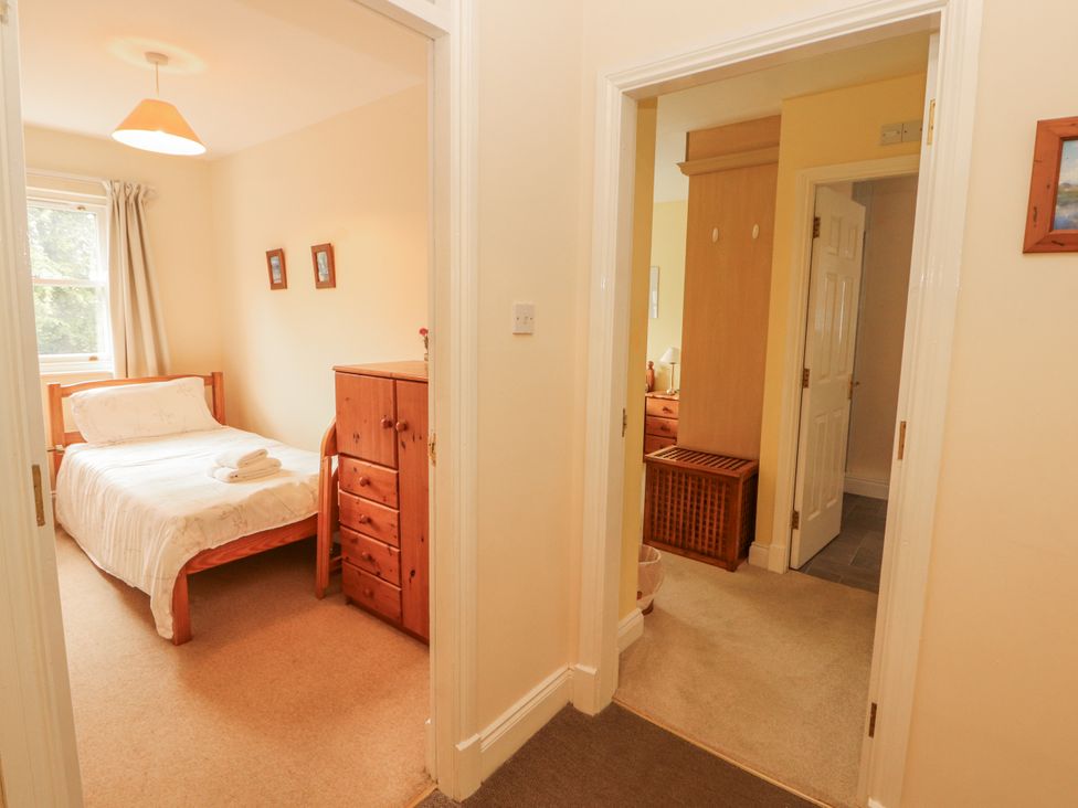 A bedroom with a bed and storage furniture at Flat 17 in Keswick