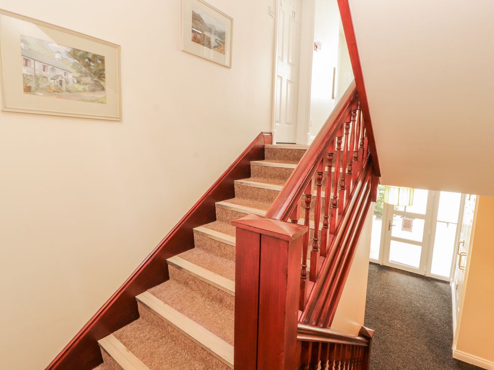 A staircase with framed pictures on the wall at Flat 17 in Keswick