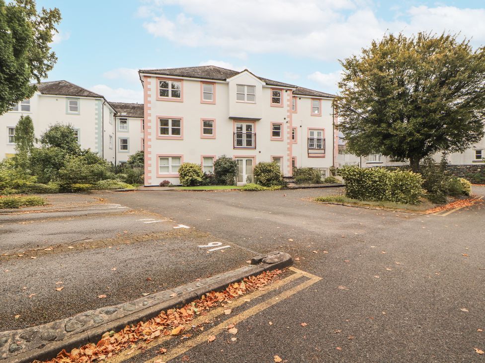A building with parking lot and trees at Flat 17 in Keswick