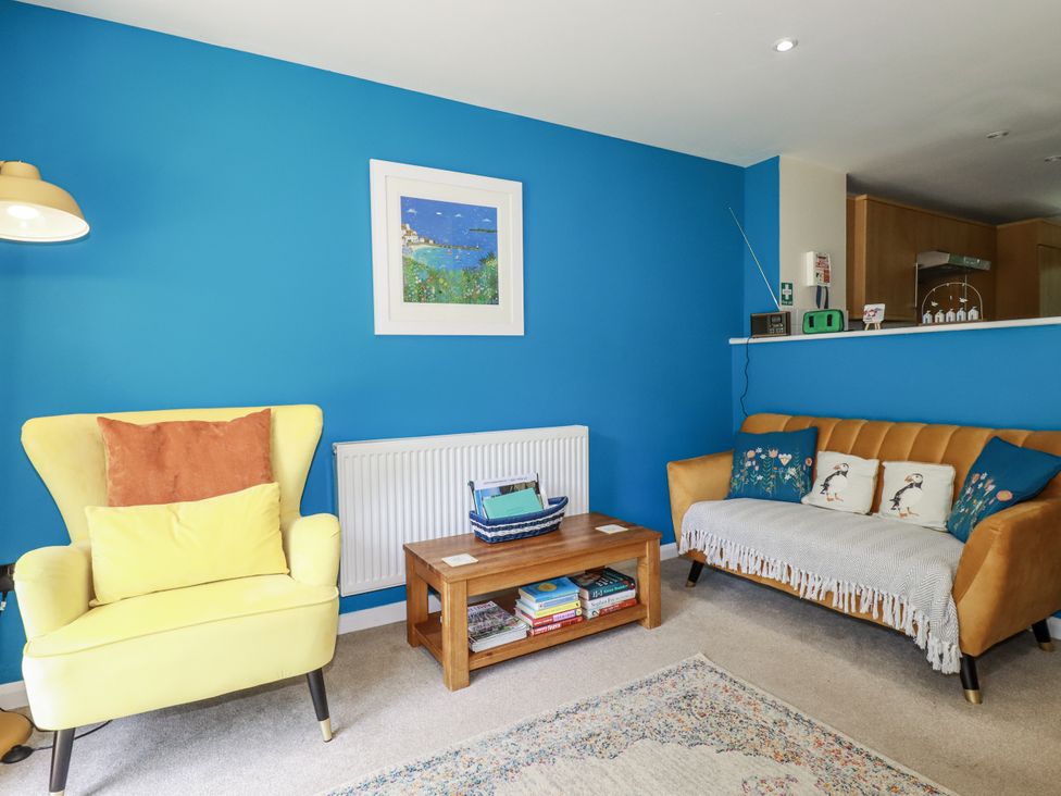 A living room with seating and a coffee table at 64 St Columb Road