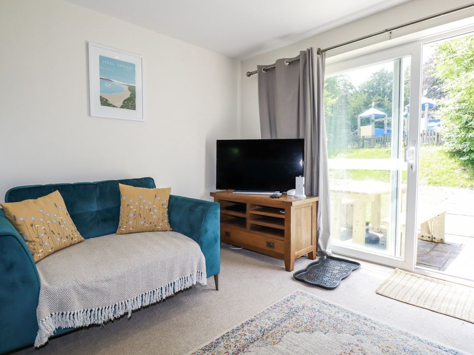 A living room with a sofa and television at 64 St Columb Road