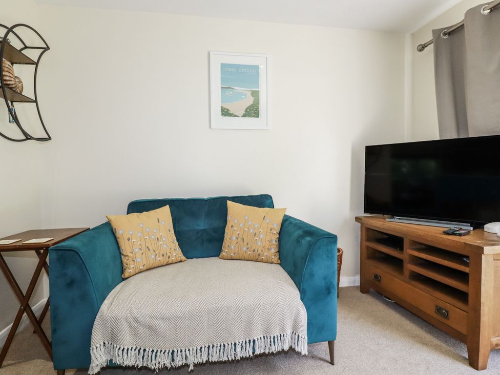 A living room with a sofa and television at 64 St Columb Road