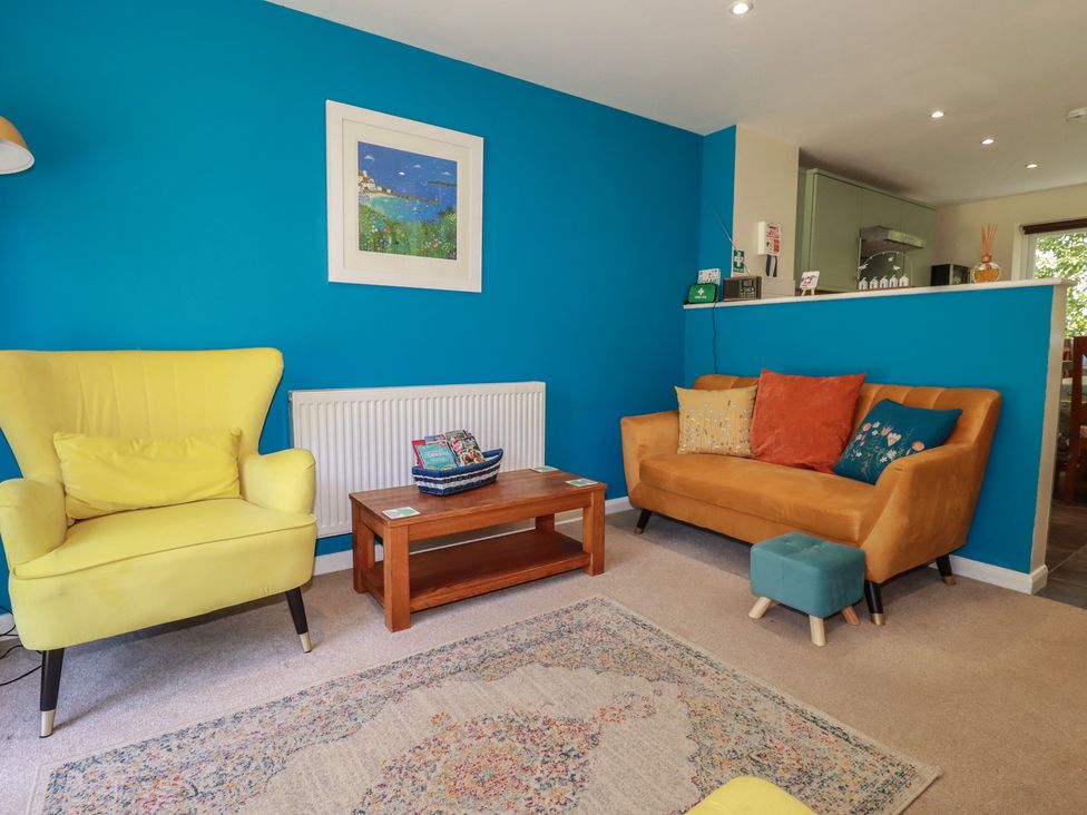 A living room with a sofa and armchair at 64 St Columb Nr Newquay