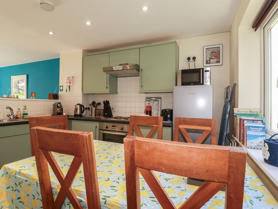 A kitchen with a table and chairs at 64 St Columb Nr Newquay