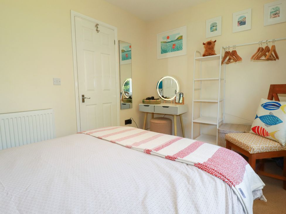 A bedroom with a bed and a desk at 64 St Columb Nr Newquay