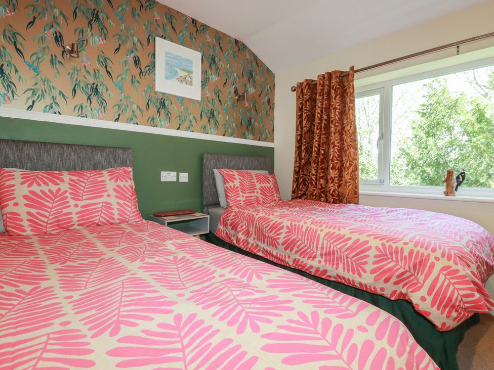 A bedroom with two beds and a window at 64 St Columb Nr Newquay