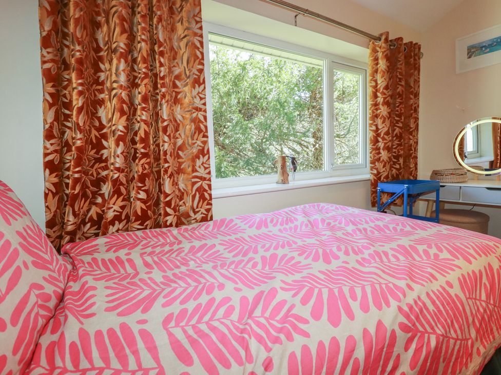 A bedroom with a bed and window at 64 St Columb Nr Newquay