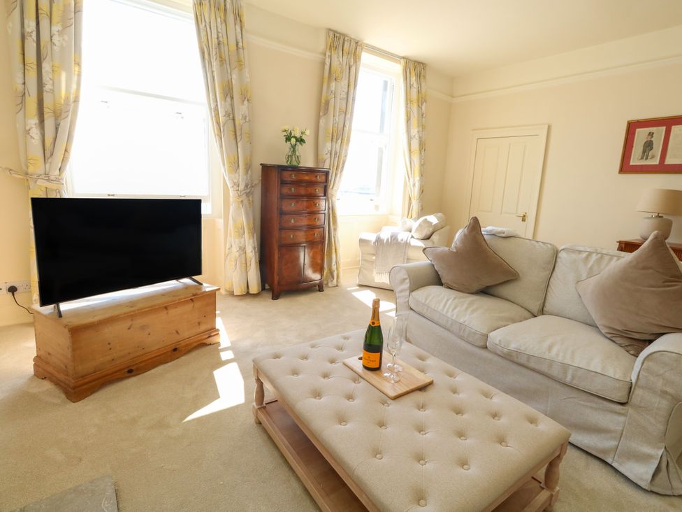 A living room with a television and a sofa at 123 On The Sea – Victoria’s Place, Weymouth