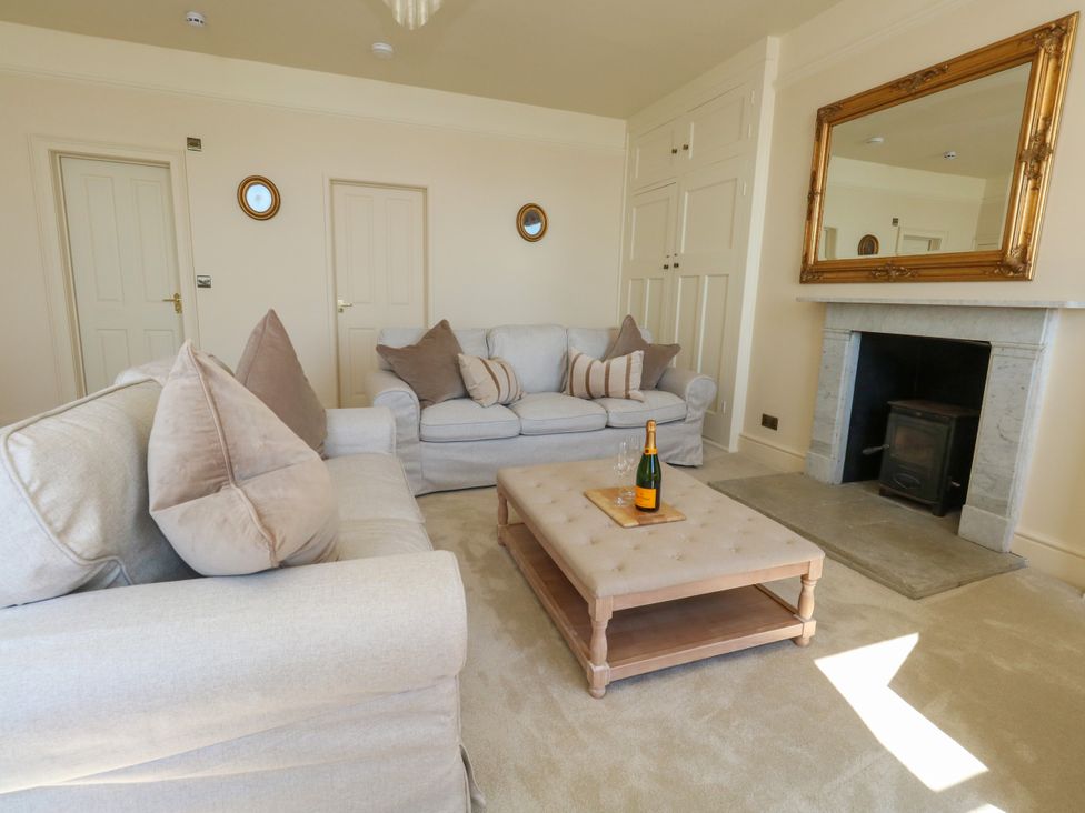 A living room with a sofa and coffee table at 123 On The Sea – Victoria’s Place in Weymouth