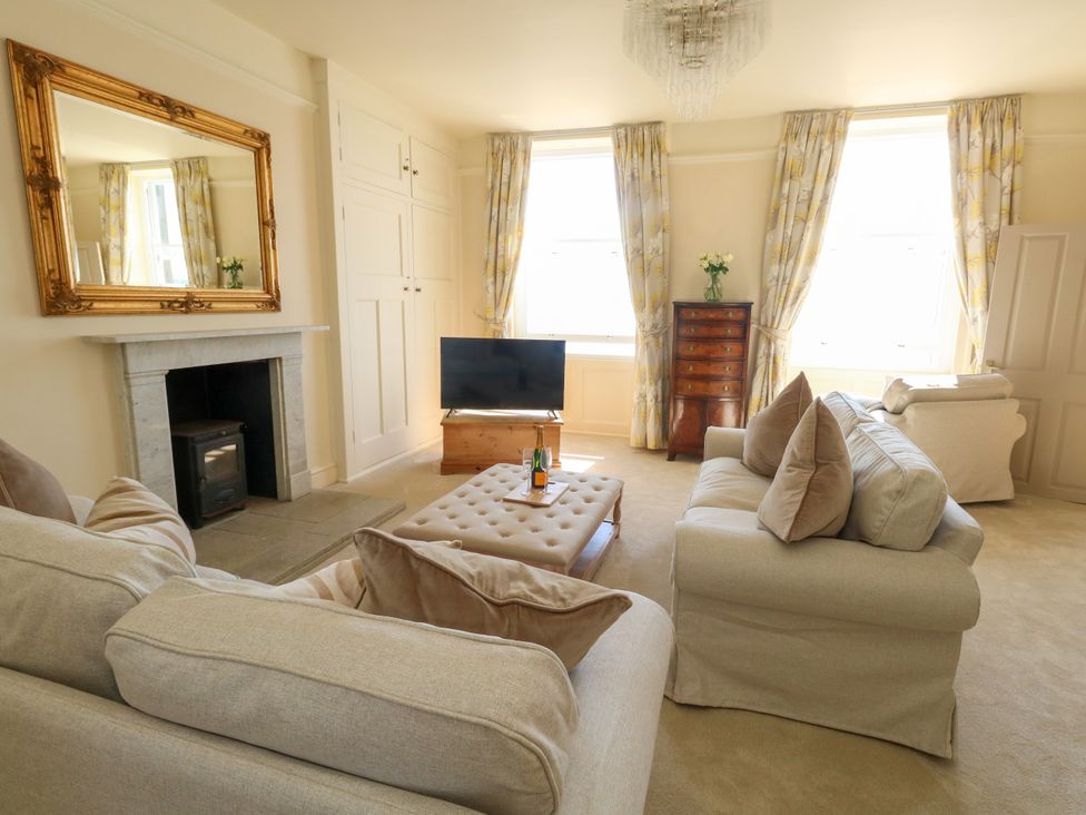 A living room with a sofa and television at 123 On The Sea – Victoria’s Place, Weymouth