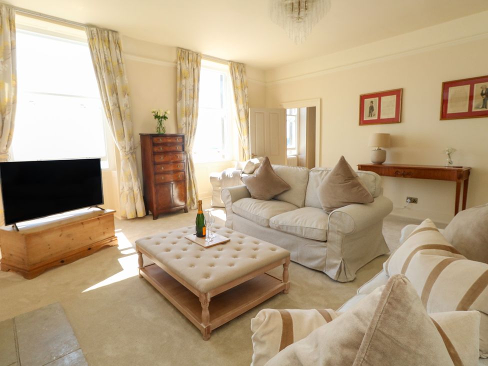 A living room with a television and sofa at 123 On The Sea – Victoria’s Place in Weymouth