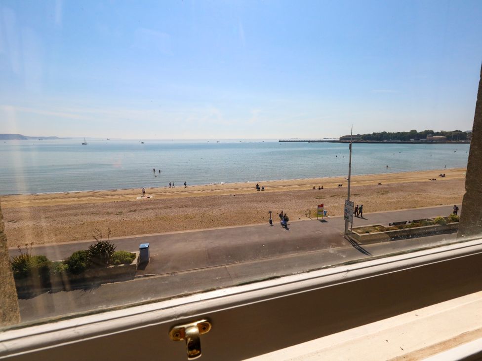 A view of the beach and sea from a window at 123 On The Sea – Victoria’s Place, Weymouth