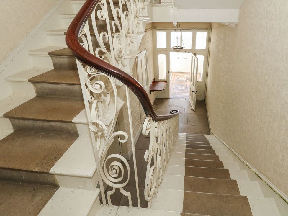 A staircase leading to a door at 123 On The Sea – Victoria’s Place in Weymouth