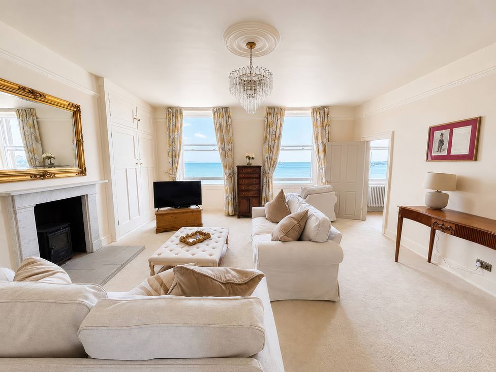 A living room with a television and a coffee table at 123 On The Sea – Victoria’s Place, Weymouth