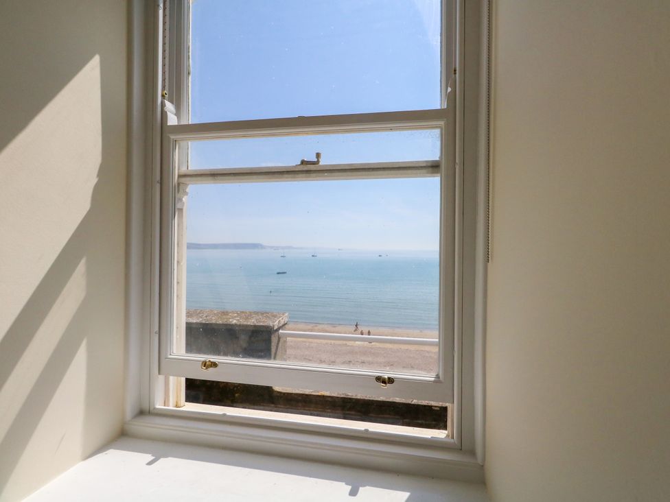 A view of the sea and beach from a window at 123 On The Sea – The Eaves Weymouth