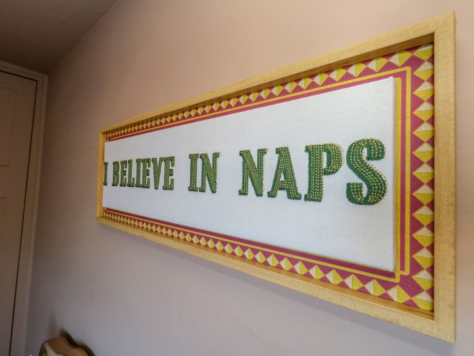 A wall art with the text I BELIEVE IN NAPS at 123 On The Sea – The Eaves, Weymouth