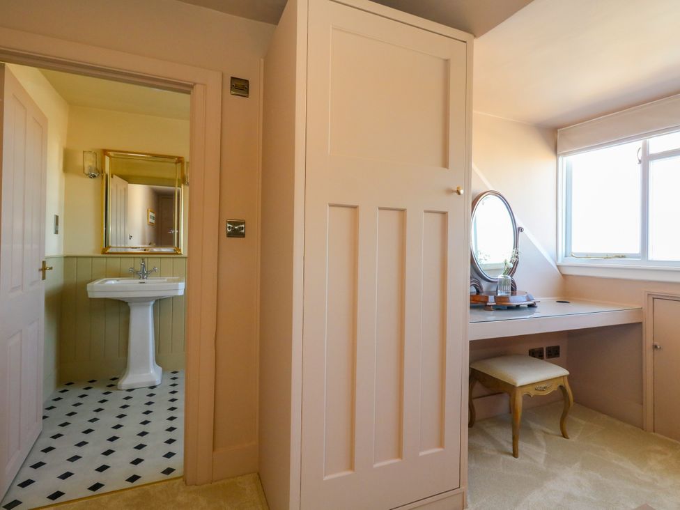 A bathroom with a sink and mirror at 123 On The Sea – The Eaves in Weymouth