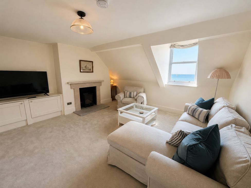 A living room with a television and sofa at 123 On The Sea – The Eaves, Weymouth