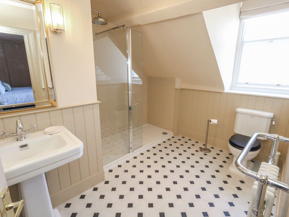 A bathroom with a sink, shower, and toilet at 123 On The Sea – The Eaves Weymouth