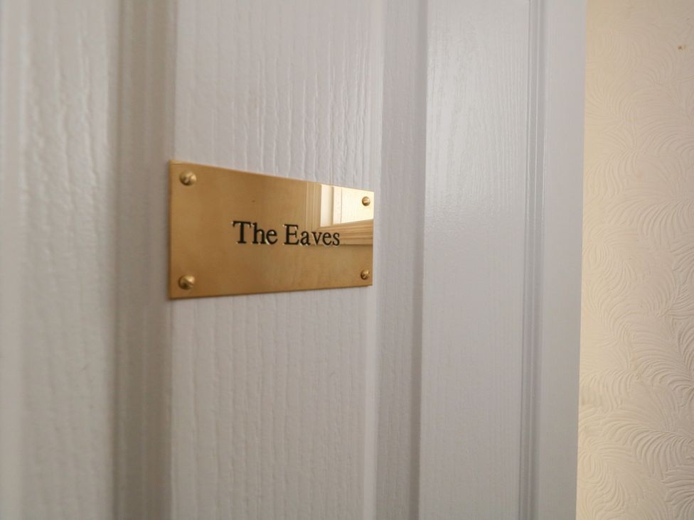 A door with a nameplate reading The Eaves at The Eaves in Weymouth