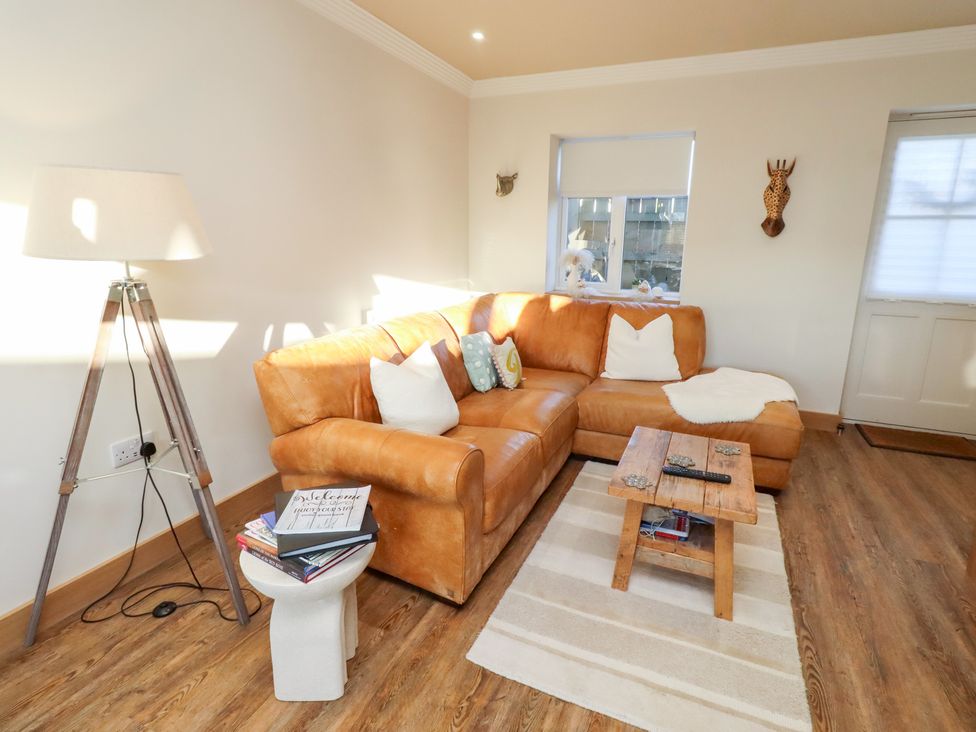 A living room with a sofa and a side table at Nene's Nest in Alnwick
