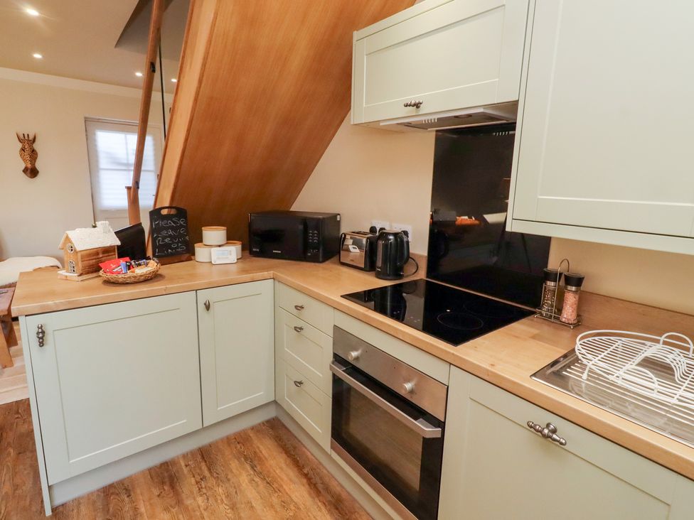 A kitchen with a sink and oven at Nene's Nest in Alnwick
